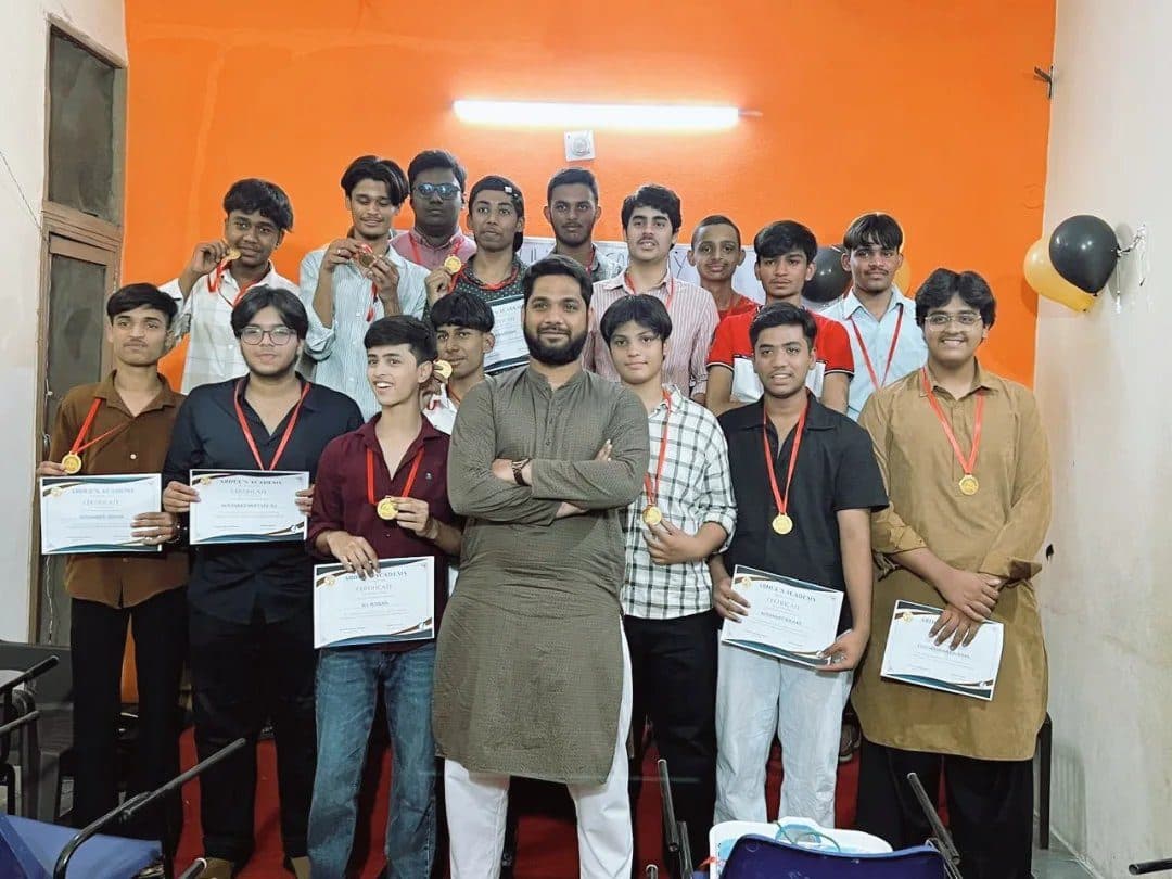 Students of the Class 10 batch of 2025-26 holding their certificates and medals on Felicitation Day, with Abdul Hadi Sir